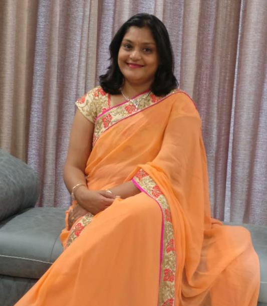 Dr. Kaveri Mootha sitting on sofa