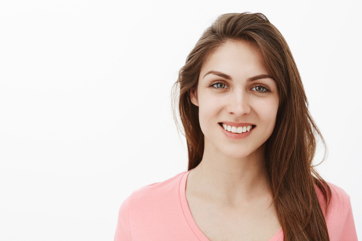 Close-up shot of friendly brunette woman posing in the studio